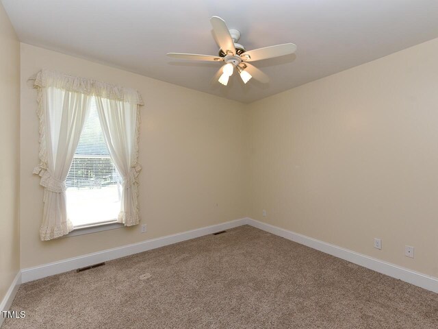 2371 NC-210, Smithfield, NC 27577 - unfurnished room featuring ceiling fan, carpet flooring, and baseboards