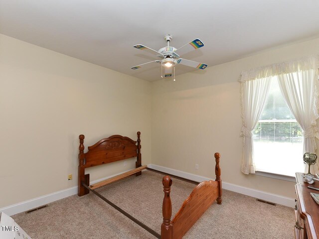 2371 NC-210, Smithfield, NC 27577 - carpeted bedroom with baseboards and ceiling fan