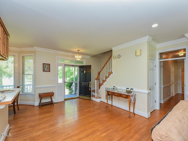 2371 NC-210, Smithfield, NC 27577 - foyer entrance featuring light wood-style flooring, a chandelier, stairs, crown molding, and baseboards