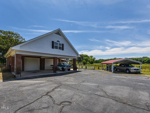 2371 NC-210, Smithfield, NC 27577 - view of side of home with a garage, brick siding, and a carport