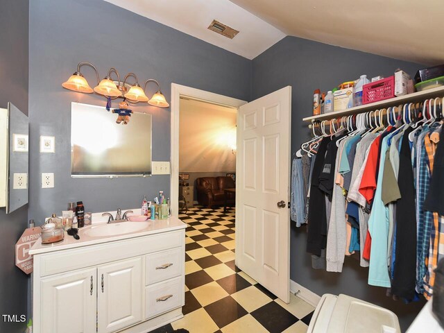 2371 NC-210, Smithfield, NC 27577 - bathroom with tile patterned floors, lofted ceiling, and vanity