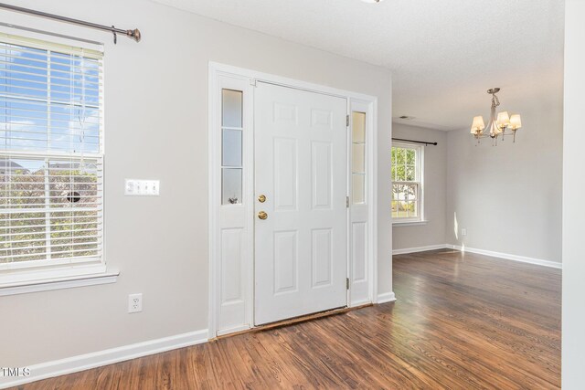 203 Downing Bluff Dr, Morrisville, NC 27560 - foyer entrance featuring baseboards, wood finished floors, and a notable chandelier