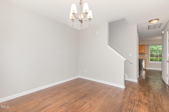 203 Downing Bluff Dr, Morrisville, NC 27560 - unfurnished room with a notable chandelier, dark wood finished floors, stairs, baseboards, and visible vents