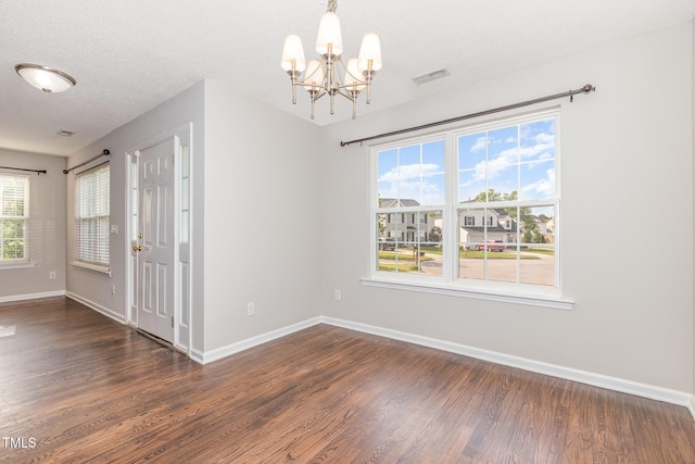 203 Downing Bluff Dr, Morrisville, NC 27560 - unfurnished dining area featuring visible vents, baseboards, dark wood-style floors, and an inviting chandelier
