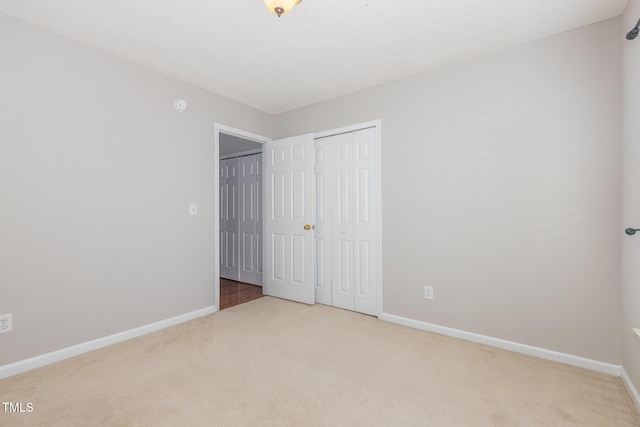 203 Downing Bluff Dr, Morrisville, NC 27560 - unfurnished bedroom featuring a closet, baseboards, and carpet flooring