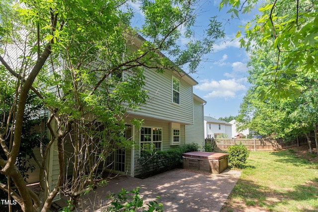 203 Downing Bluff Dr, Morrisville, NC 27560 - rear view of property featuring a lawn, a hot tub, fence, and a patio area