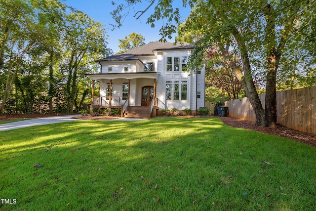 211 Page St, Morrisville, NC 27560 - view of front of property with fence, a shingled roof, a porch, and a front yard