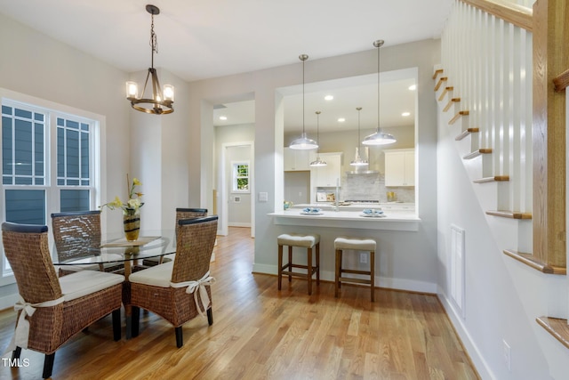 211 Page St, Morrisville, NC 27560 - dining area with visible vents, baseboards, recessed lighting, light wood-style flooring, and a notable chandelier