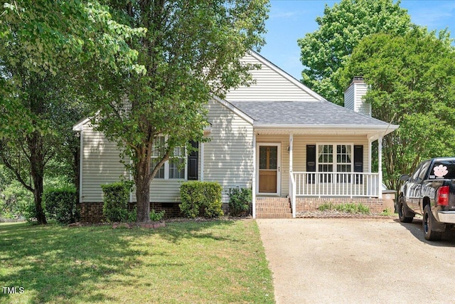 view of front of house with covered porch, a chimney, a shingled roof, and a front yard