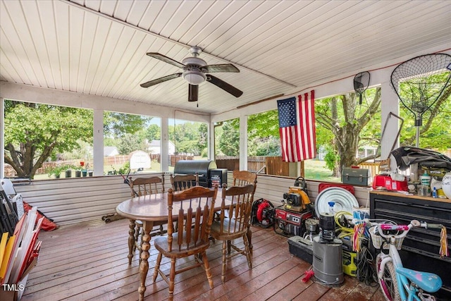 sunroom / solarium featuring a ceiling fan and outdoor dining space