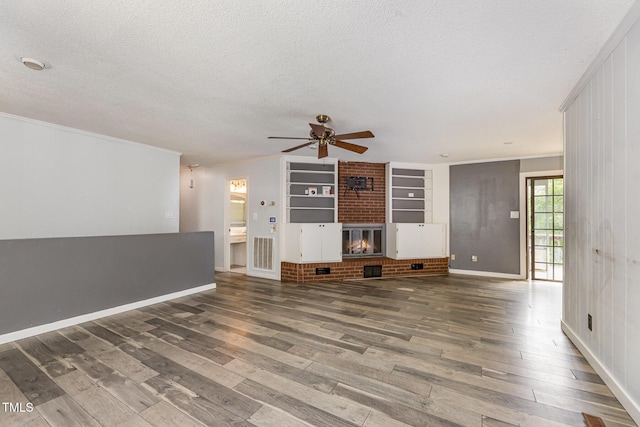 unfurnished living room featuring a textured ceiling, ceiling fan, and wood finished floors