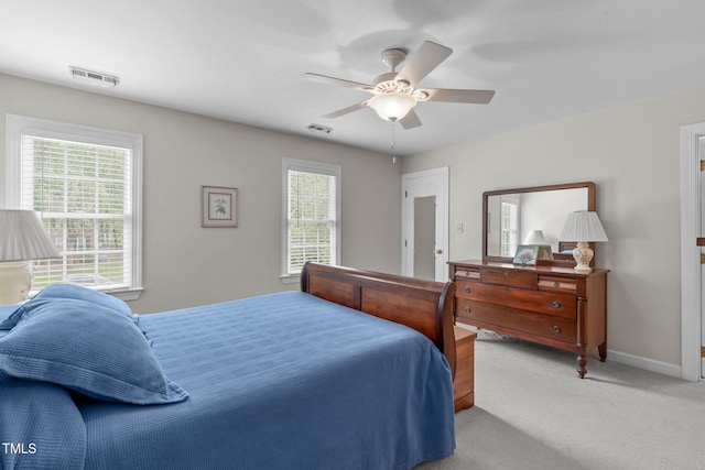 bedroom featuring light colored carpet, baseboards, and ceiling fan