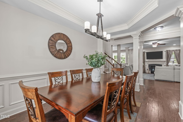 3304 Rockland Ridge Dr, Cary, NC 27519 - dining room featuring ornate columns, a glass covered fireplace, crown molding, dark wood finished floors, and ceiling fan