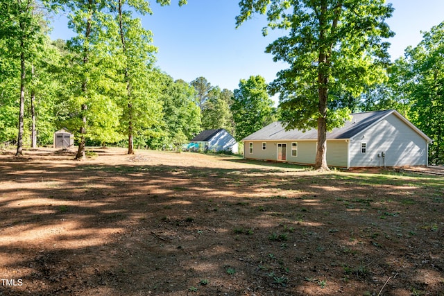 view of yard with an outdoor structure and a shed