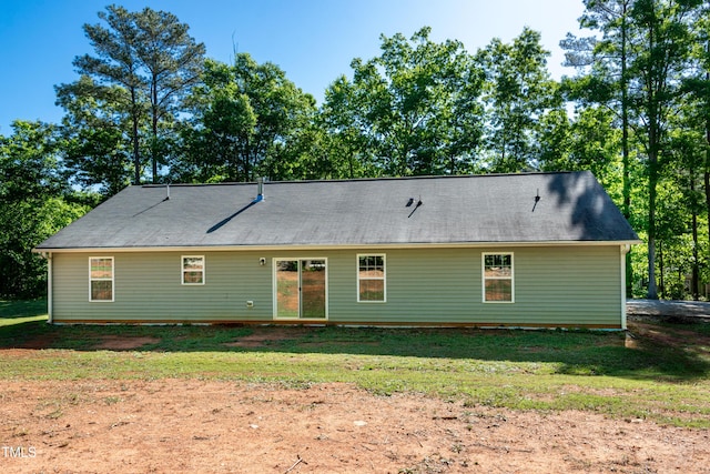 back of property with a yard