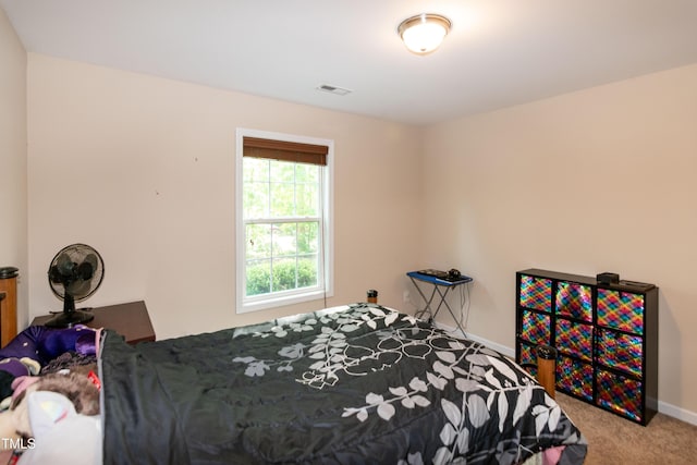 carpeted bedroom with visible vents and baseboards
