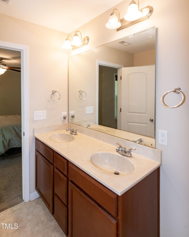 ensuite bathroom with double vanity, a sink, and ensuite bathroom