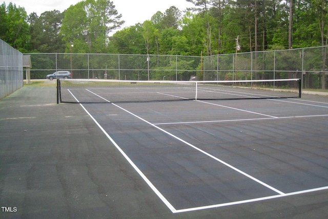 view of tennis court with fence