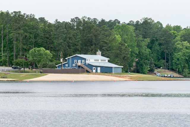 exterior space featuring a water view and a view of trees