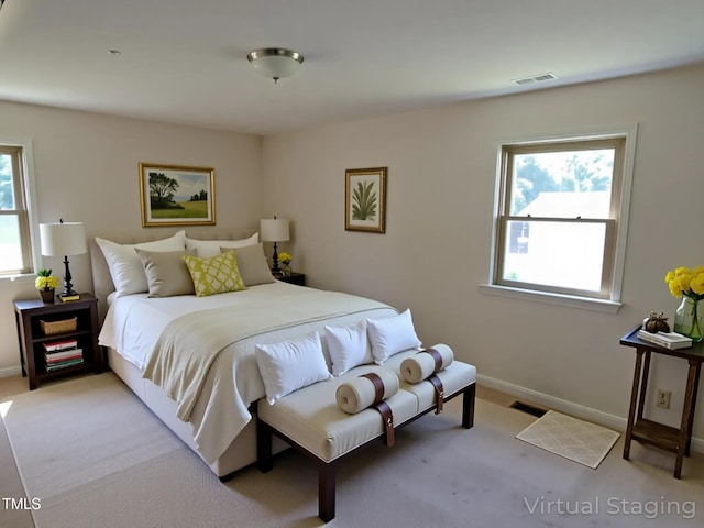 4908 Mandel Rd, Durham, NC 27712 - bedroom with multiple windows, light colored carpet, and baseboards