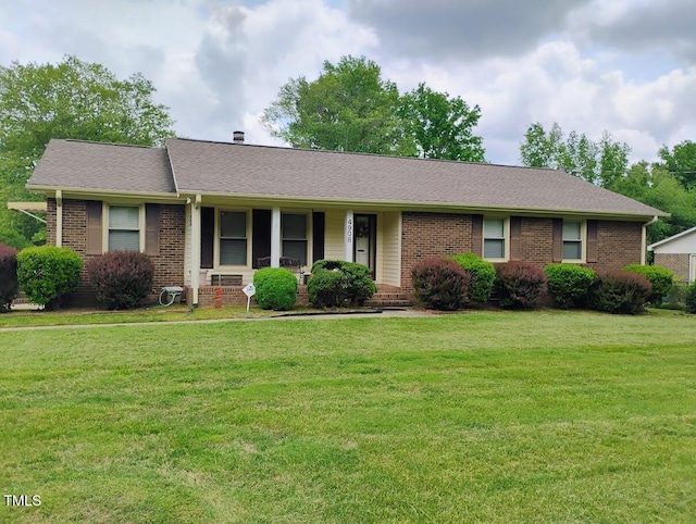 4908 Mandel Rd, Durham, NC 27712 - ranch-style house with brick siding, a porch, and a front yard