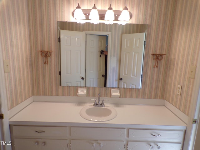 4908 Mandel Rd, Durham, NC 27712 - bathroom with wallpapered walls, vanity, and a chandelier