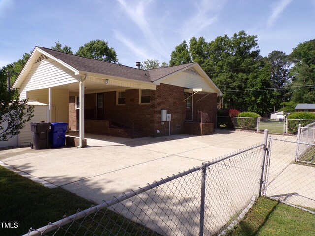 4908 Mandel Rd, Durham, NC 27712 - view of side of property with a gate, fence, and brick siding