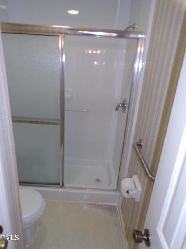 4908 Mandel Rd, Durham, NC 27712 - bathroom featuring a stall shower, toilet, and tile patterned floors