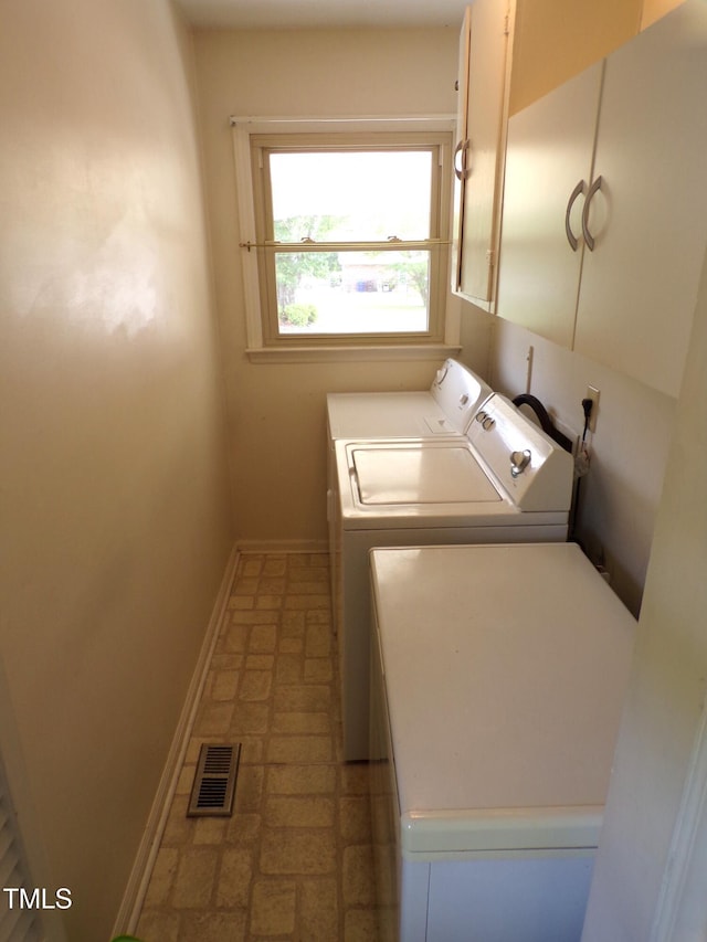 4908 Mandel Rd, Durham, NC 27712 - clothes washing area with separate washer and dryer, cabinet space, and baseboards