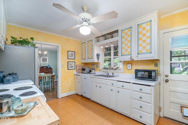 kitchen with black microwave, white dishwasher, plenty of natural light, light countertops, and a sink
