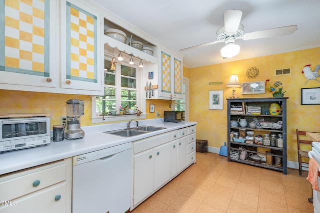 kitchen with visible vents, light floors, light countertops, a sink, and dishwasher