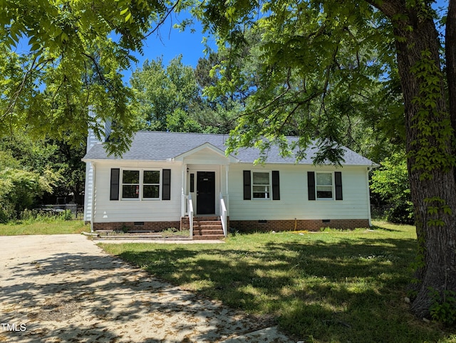 view of front of house with crawl space, a front yard, and roof with shingles