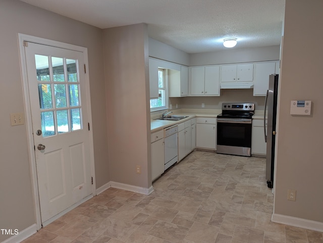 kitchen featuring appliances with stainless steel finishes, light countertops, baseboards, white cabinets, and under cabinet range hood
