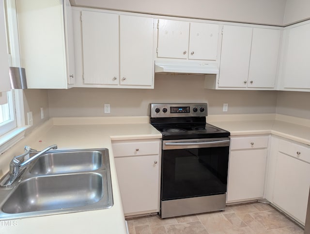 kitchen featuring a sink, stainless steel electric range oven, under cabinet range hood, and white cabinetry