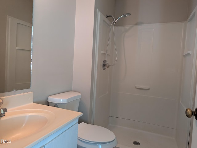 full bath featuring vanity, a stall shower, and toilet