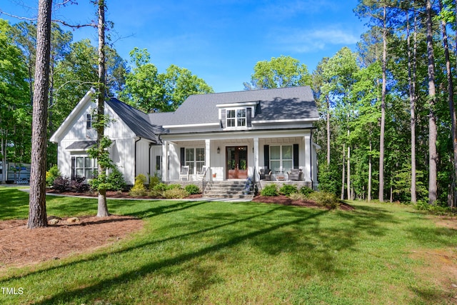 view of front of house featuring french doors, board and batten siding, a porch, and a front yard
