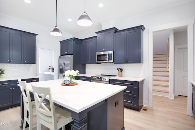 kitchen featuring a center island, tasteful backsplash, stainless steel appliances, and recessed lighting
