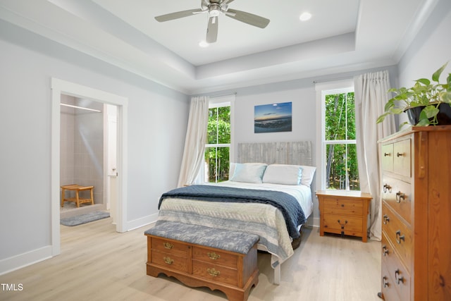 bedroom featuring baseboards, multiple windows, and light wood finished floors