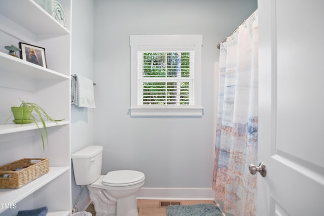 full bath with visible vents, baseboards, wood finished floors, and toilet