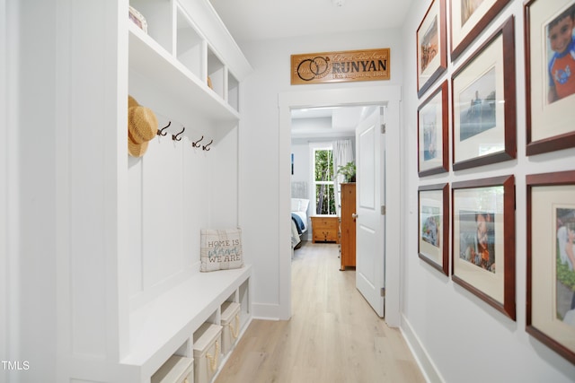 mudroom with light wood-style floors and baseboards