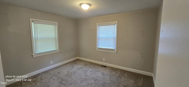 carpeted empty room with baseboards