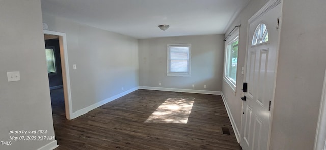 foyer featuring dark wood-style floors and baseboards