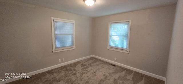empty room with baseboards and carpet floors