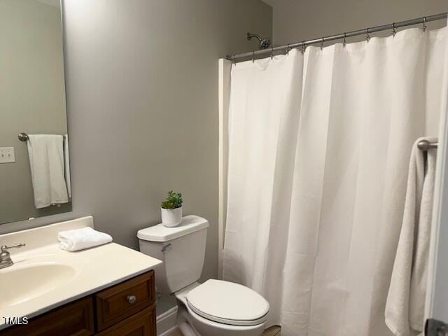 1003 Red Sunset Dr, Apex, NC 27502 - full bathroom with vanity, toilet, and a shower with curtain