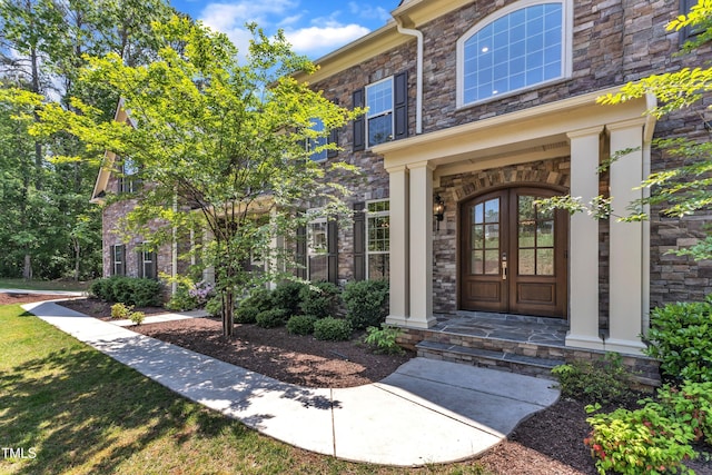 property entrance with french doors and stone siding