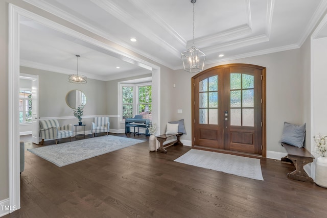 foyer featuring dark wood-style flooring, an inviting chandelier, plenty of natural light, and french doors