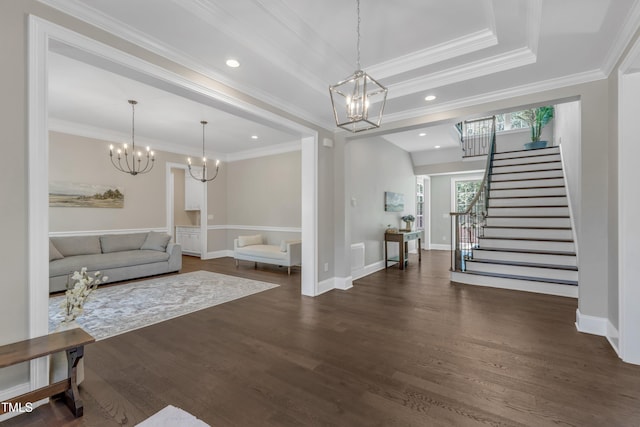 living area with an inviting chandelier, stairs, crown molding, and dark wood finished floors