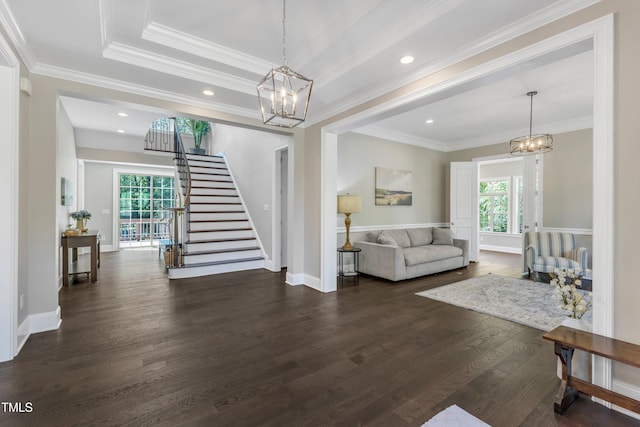 living room with stairway, a wealth of natural light, and a chandelier
