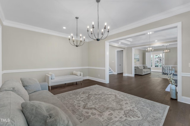 living area with crown molding, stairs, a chandelier, and dark wood-style floors
