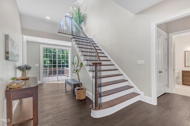 stairway with baseboards, recessed lighting, and wood finished floors